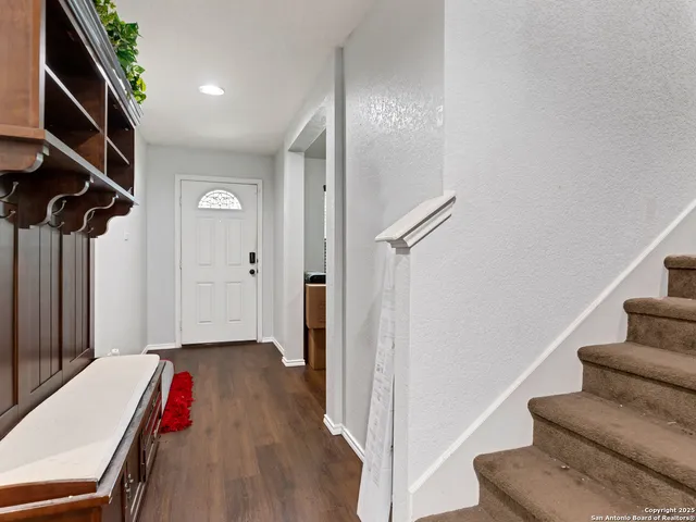 a view of entryway with stairs and wooden floor