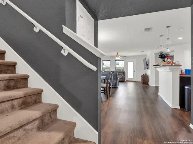 a view of living room with furniture and wooden floor