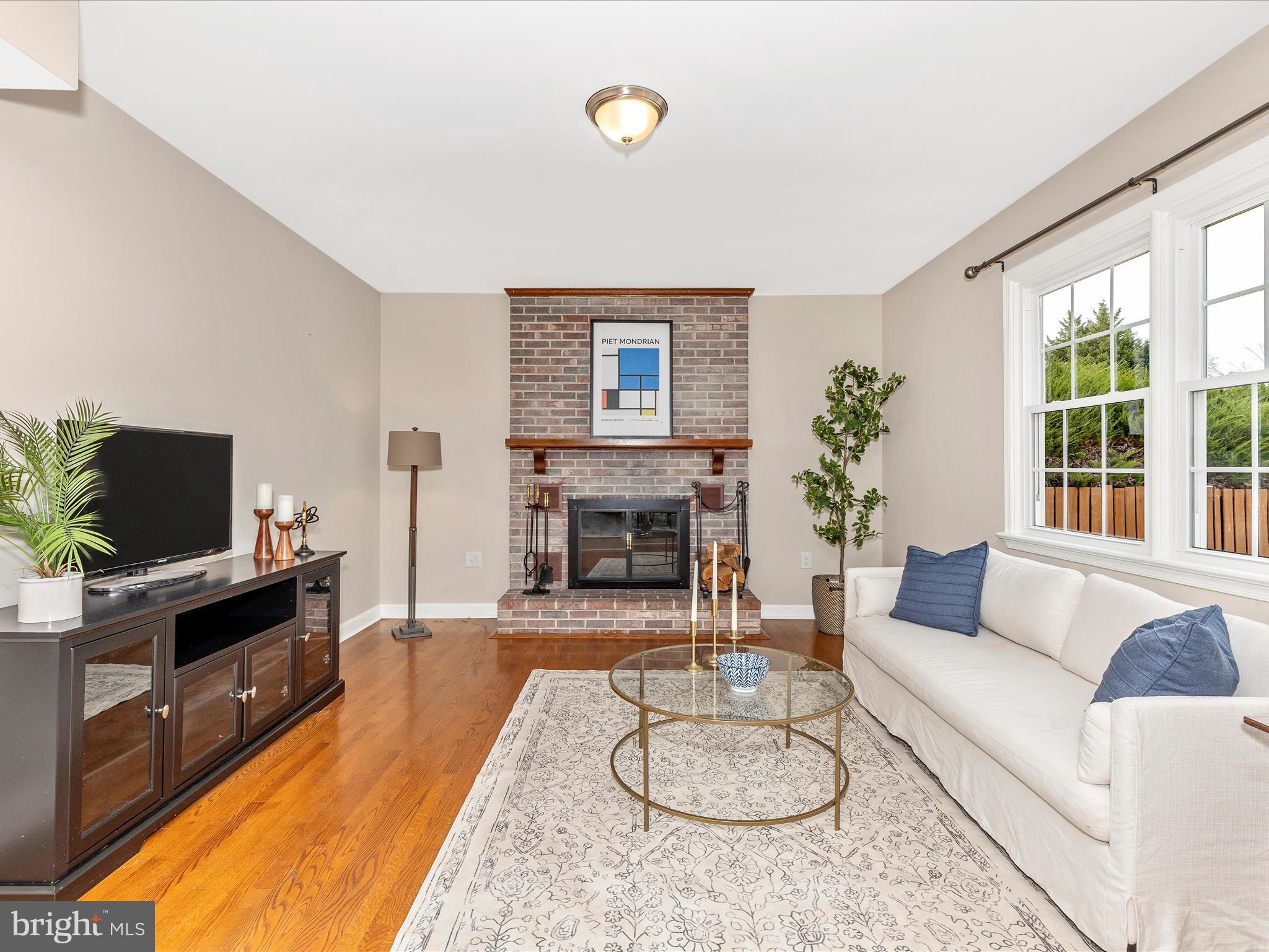 7094 Autumn Leaf Lane Frederick, MD 21702 - Photo 11 of 43 a living room with furniture a fireplace and a flat screen tv