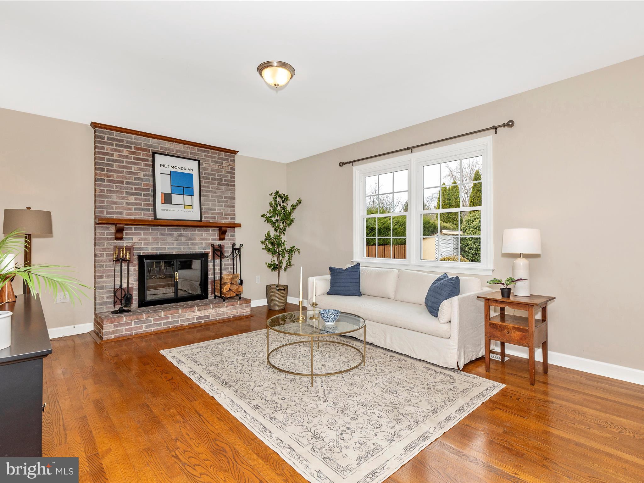 7094 Autumn Leaf Lane Frederick, MD 21702 - Photo 12 of 43 a living room with furniture a fireplace and a large window