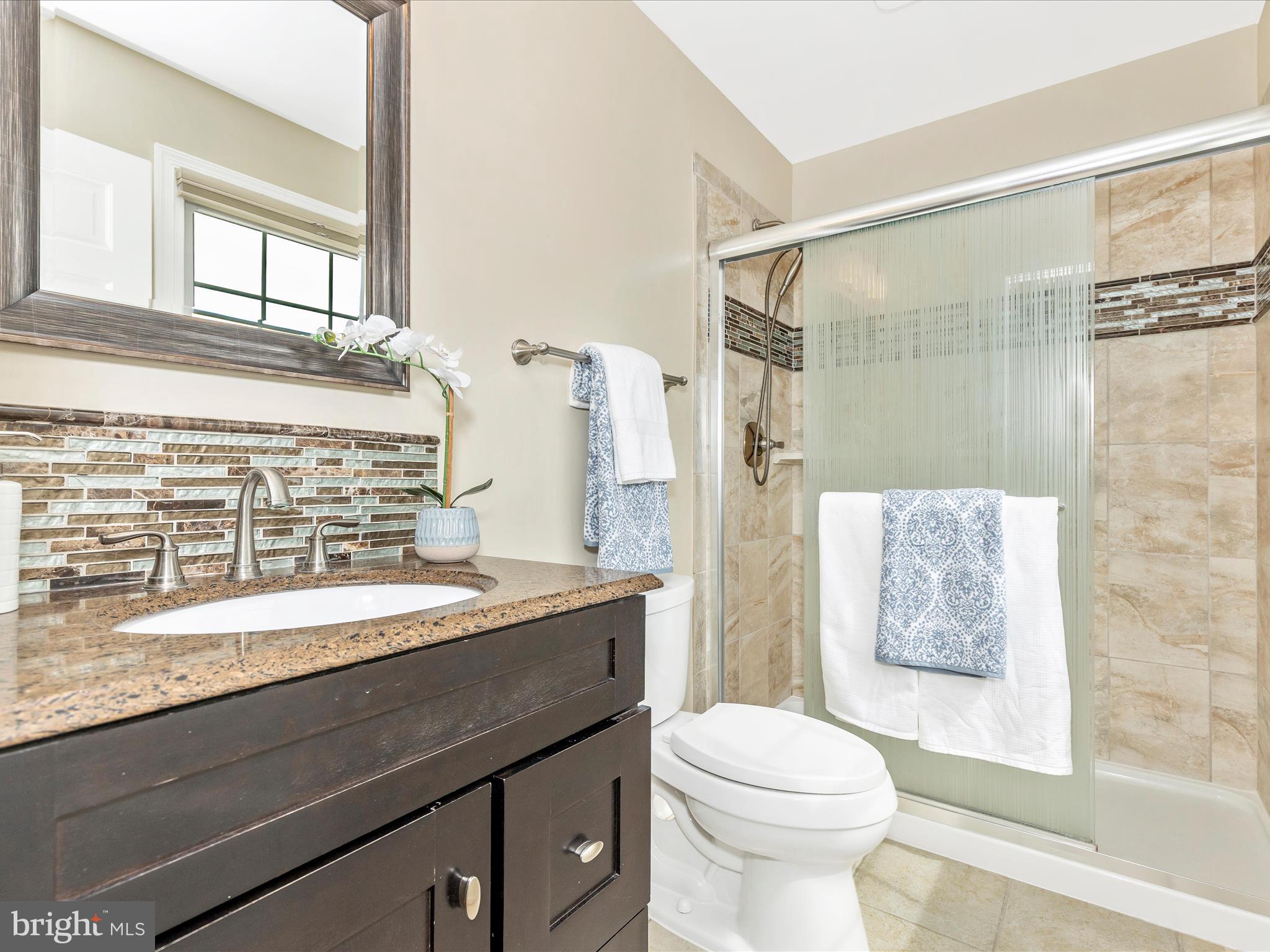 7094 Autumn Leaf Lane Frederick, MD 21702 - Photo 18 of 43 a bathroom with a granite countertop sink toilet and shower