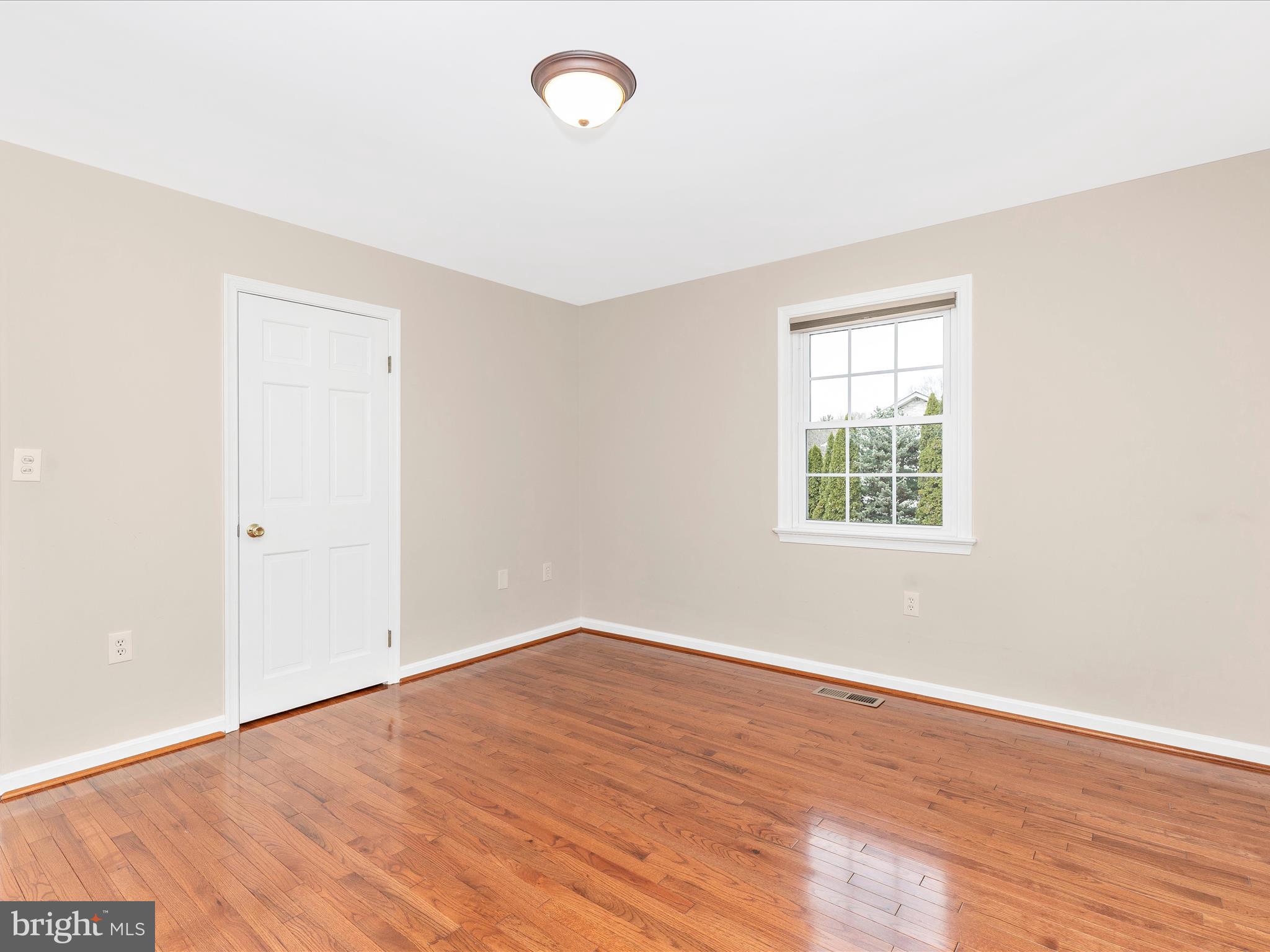 7094 Autumn Leaf Lane Frederick, MD 21702 - Photo 20 of 43 an empty room with wooden floor and windows
