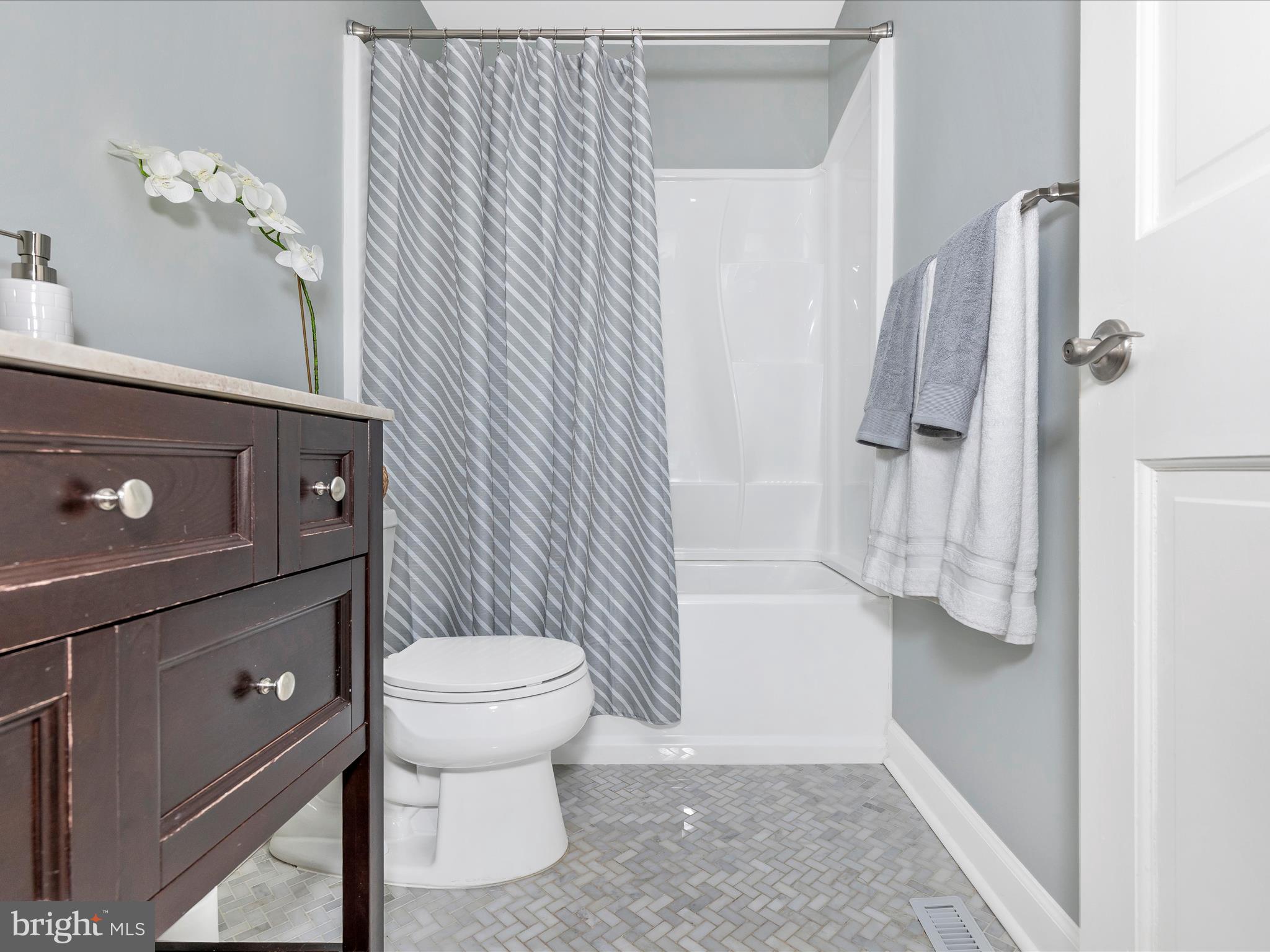 7094 Autumn Leaf Lane Frederick, MD 21702 - Photo 22 of 43 a bathroom with a sink a toilet and shower