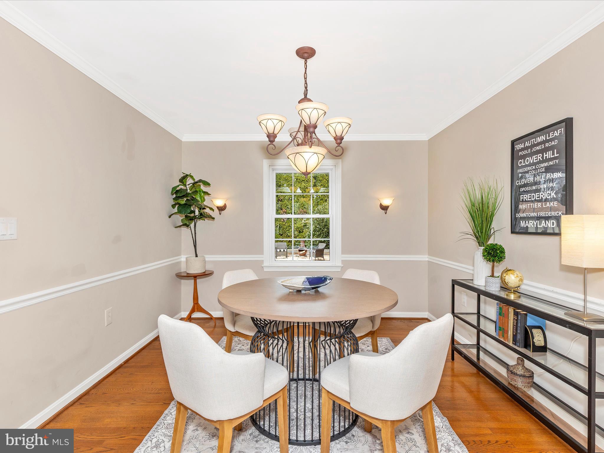 7094 Autumn Leaf Lane Frederick, MD 21702 - Photo 6 of 43 a dining room with furniture a rug and a potted plant