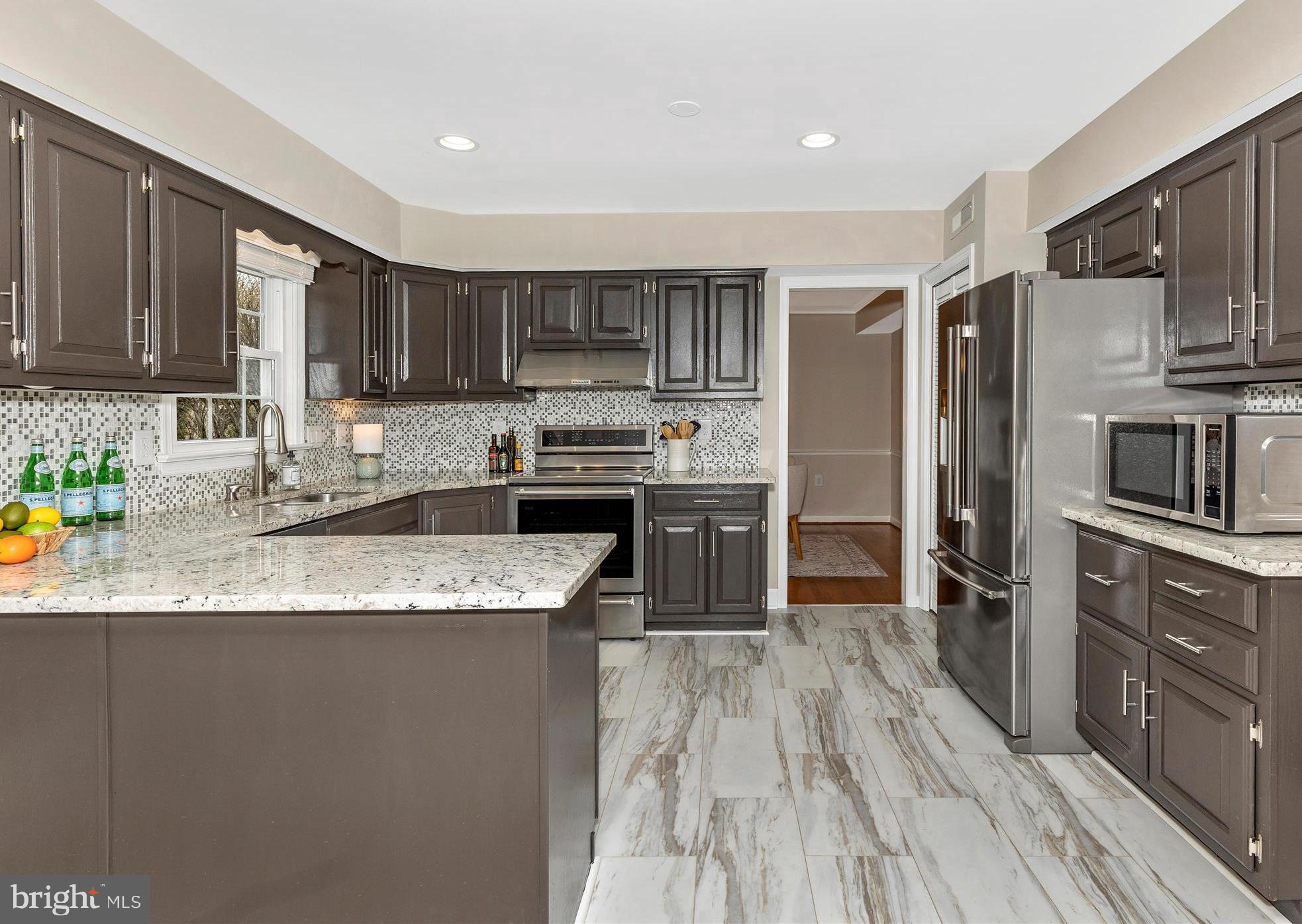 7094 Autumn Leaf Lane Frederick, MD 21702 - Photo 8 of 43 a kitchen with stainless steel appliances granite countertop a stove a sink a refrigerator and a cabinets