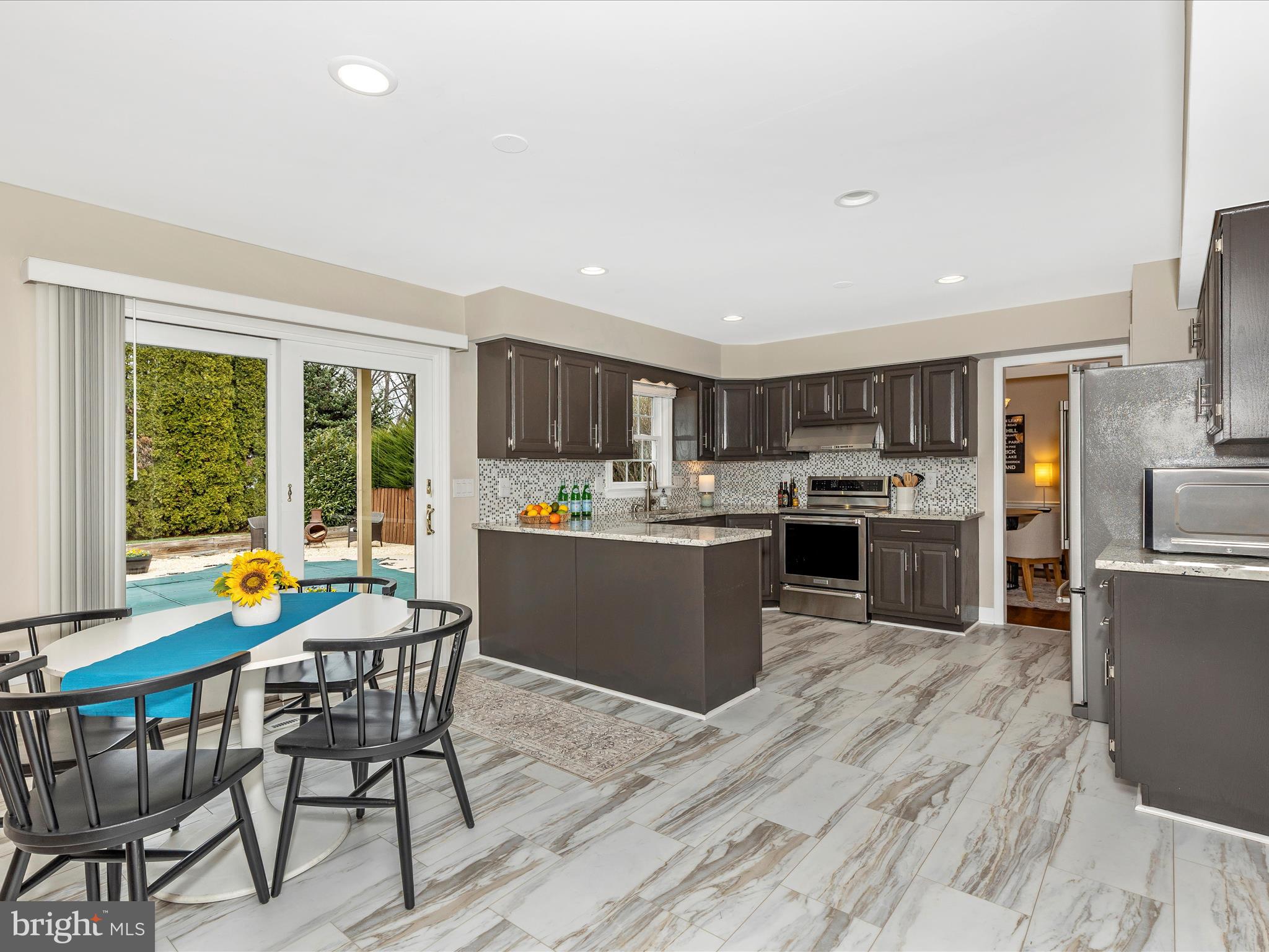 7094 Autumn Leaf Lane Frederick, MD 21702 - Photo 10 of 43 a kitchen with a table chairs refrigerator and cabinets