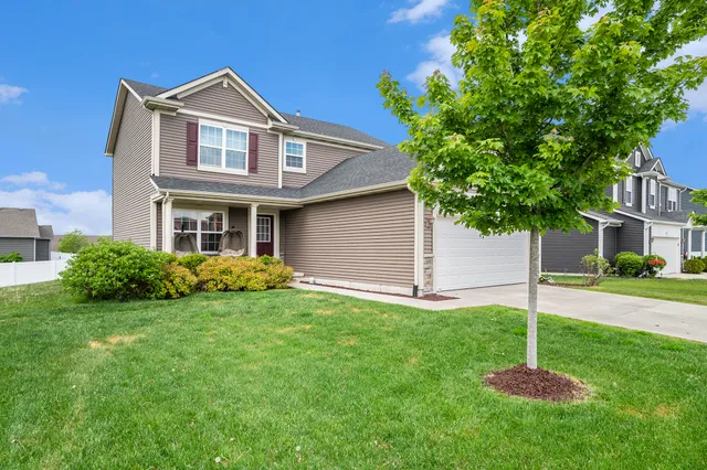 a front view of a house with a yard