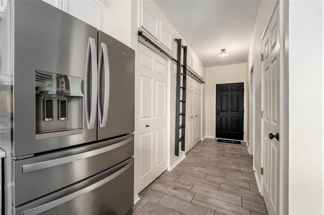 a kitchen with stainless steel appliances a refrigerator and cabinets