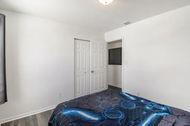 a room with a rug and wooden floor