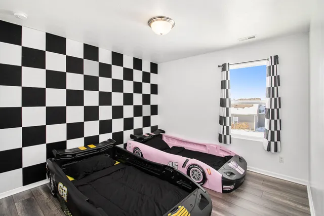 a bedroom with a bed and a mirror