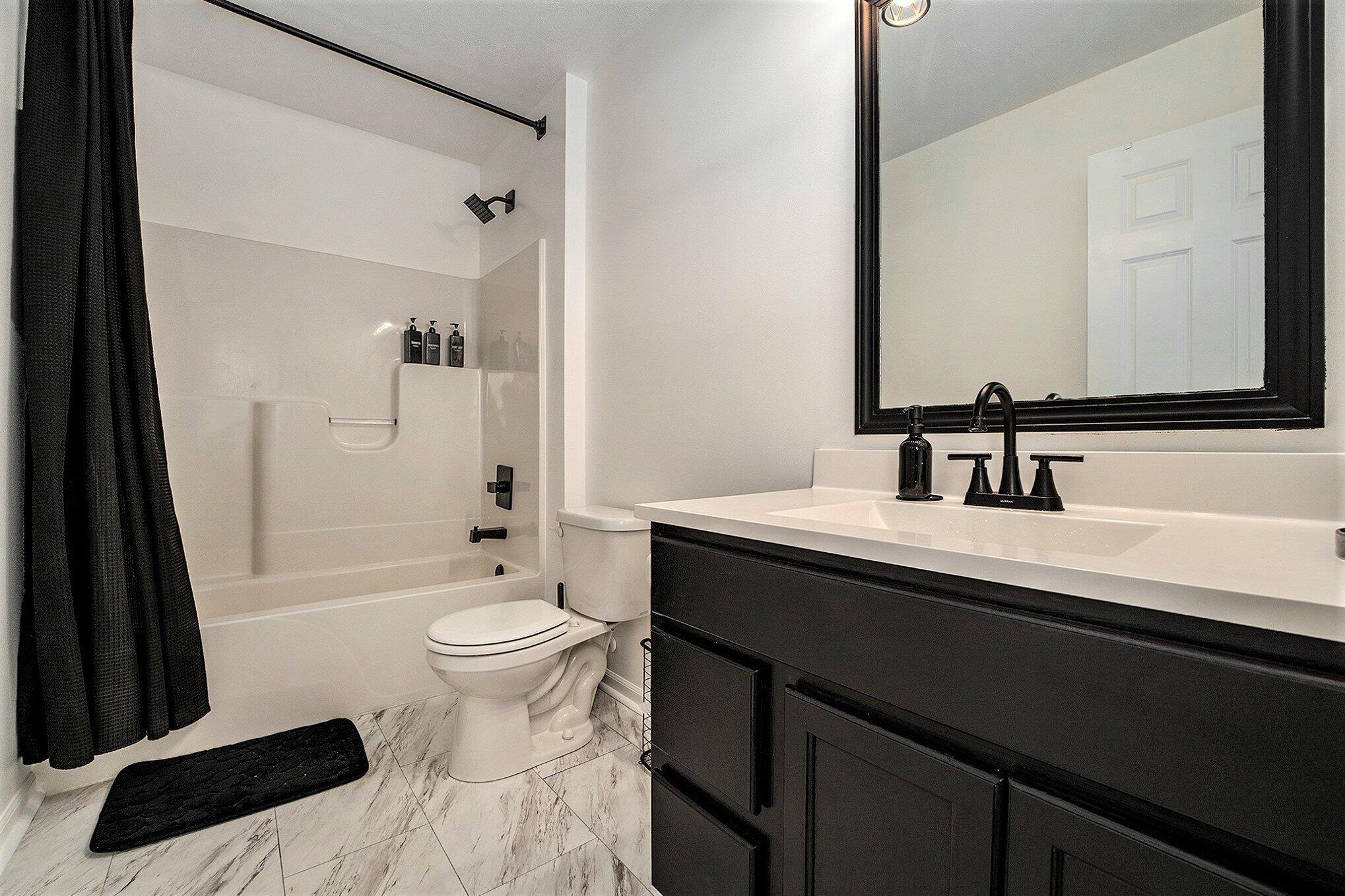 3700 Sagebrook Street Portage, IN 46368 - Photo 28 of 42 a bathroom with a sink a toilet a mirror and shower