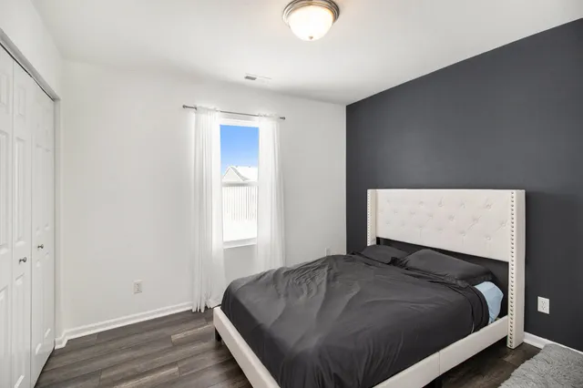 a bedroom with a bed and window