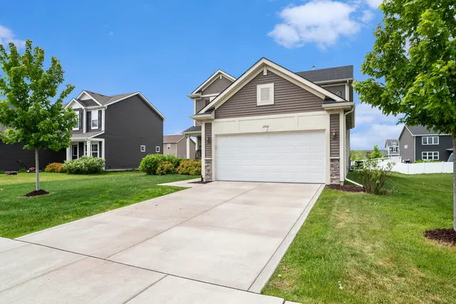a front view of a house with a yard and garage