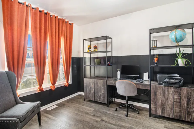 a living room with furniture a flat screen tv and a window