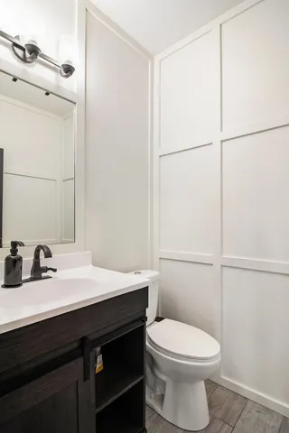 a bathroom with a sink a toilet and mirror