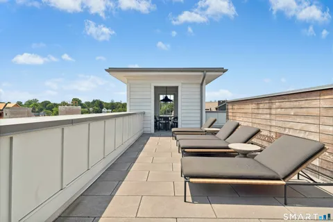 a view of a patio with a table and chairs