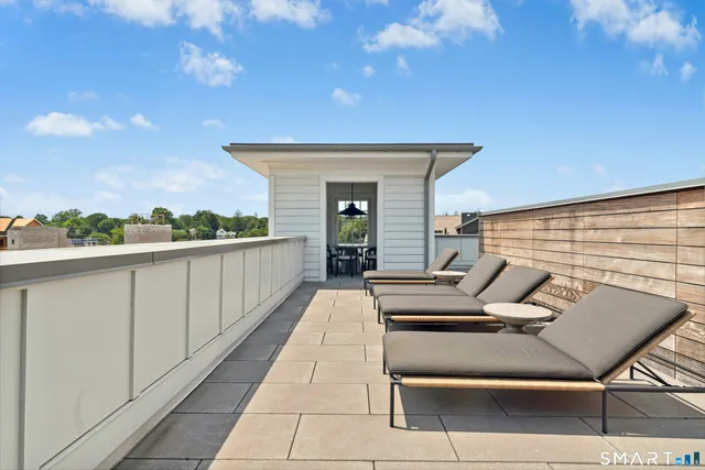 a view of a patio with a table and chairs