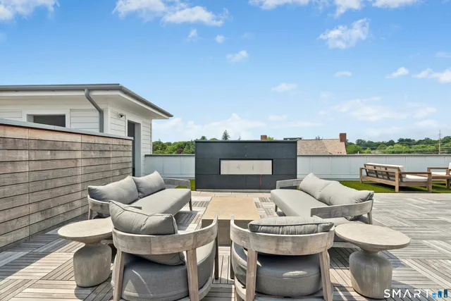 a balcony with furniture and a fireplace