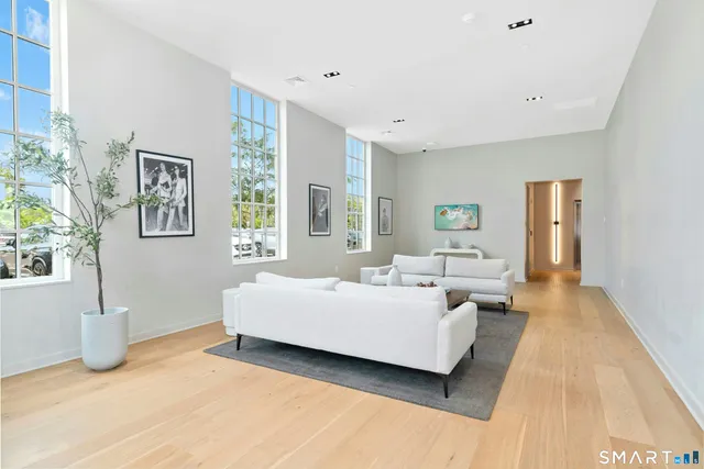 a spacious bedroom with a bed a couch and a window