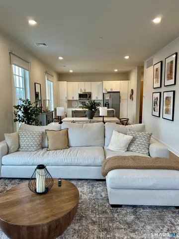 a living room with furniture and a dining table