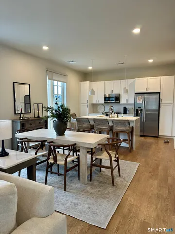 a living room with lots of furniture and kitchen view