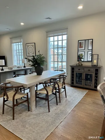 a view of a dining room with furniture window and wooden floor