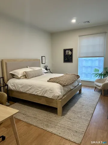 a bedroom with a bed and a couch