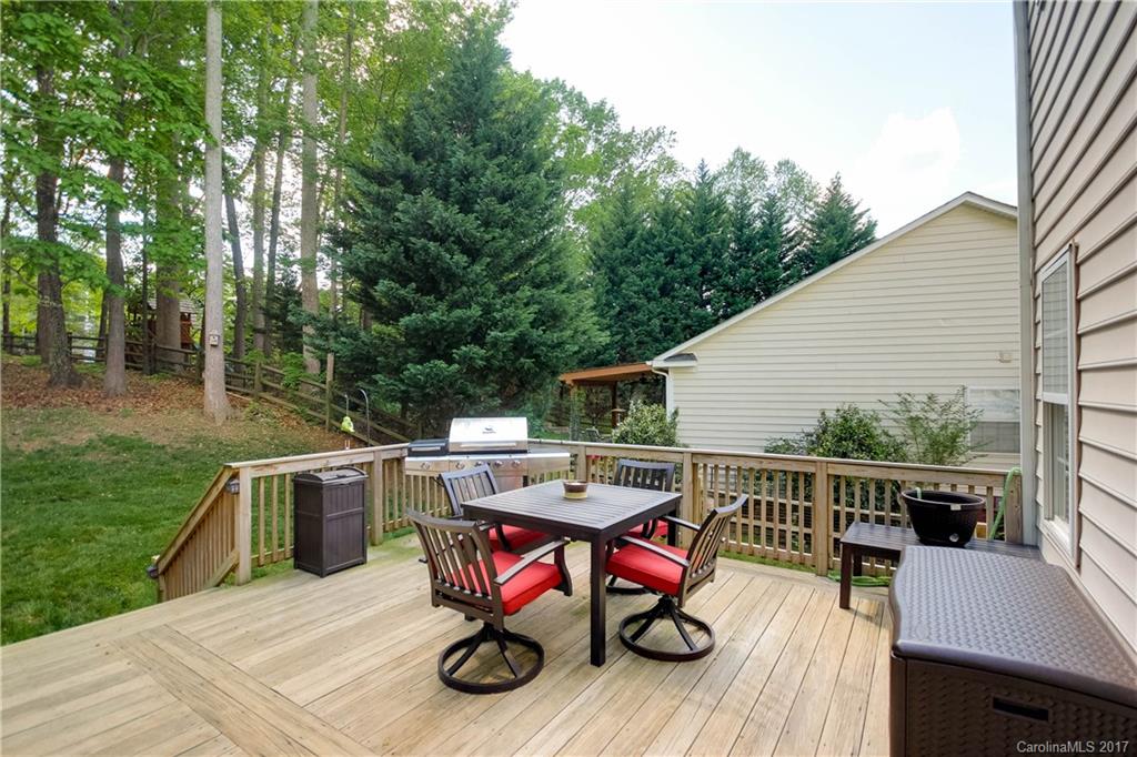 432 St George Road Fort Mill, SC 29708 - Photo 4 of 23 a view of a deck that has a table and chairs with wooden floor and fence