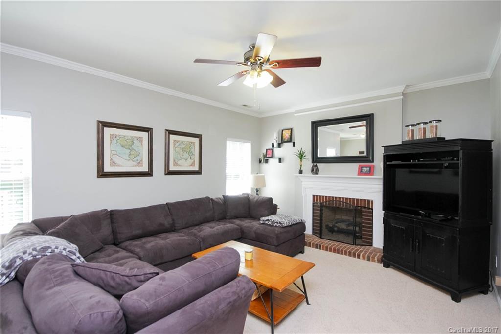 432 St George Road Fort Mill, SC 29708 - Photo 6 of 23 a living room with furniture a flat screen tv and a fireplace