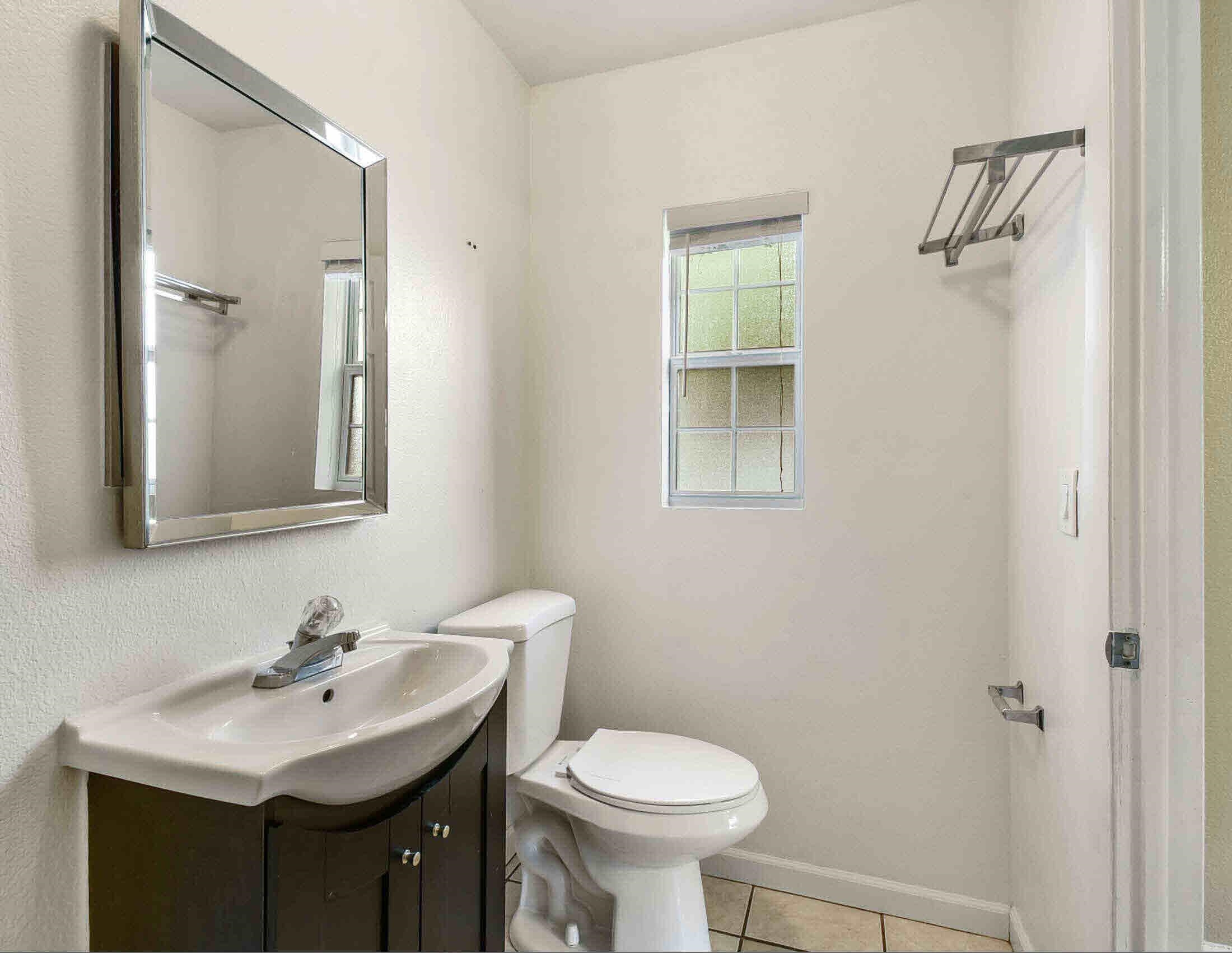 10403 Ebbitt Road Jacksonville, FL 32246 - Photo 14 of 22 a bathroom with a sink toilet and a mirror