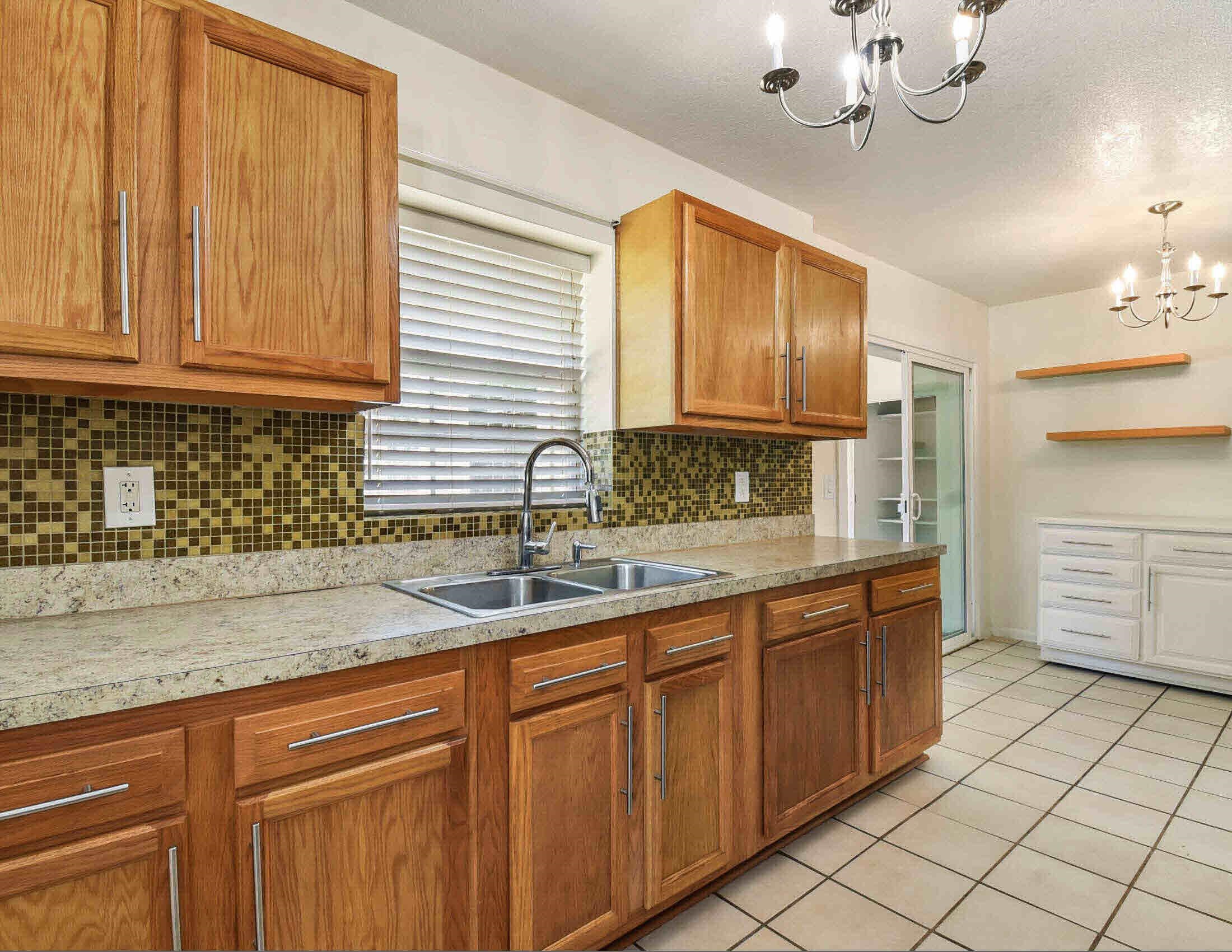 10403 Ebbitt Road Jacksonville, FL 32246 - Photo 18 of 22 a kitchen with stainless steel appliances granite countertop a sink and cabinets
