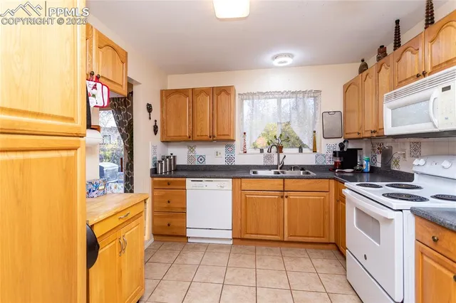 a kitchen with stainless steel appliances granite countertop a sink and cabinets