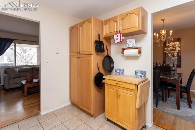 a view of kitchen and dining area with chandelier