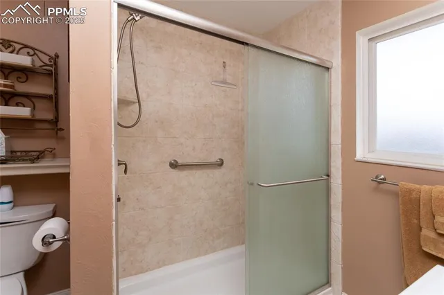 a bathroom with a glass shower door