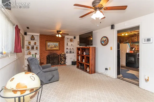 a view of a livingroom with furniture and a chandelier fan