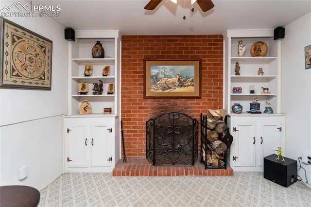 a living room with furniture and paintings on the wall