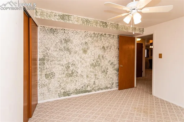 a view of a interior area with chandelier fan and fire place