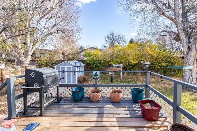 a view of a balcony with two chairs and a potted plant on a table