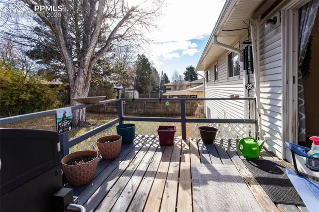 a view of balcony with chairs and wooden fence