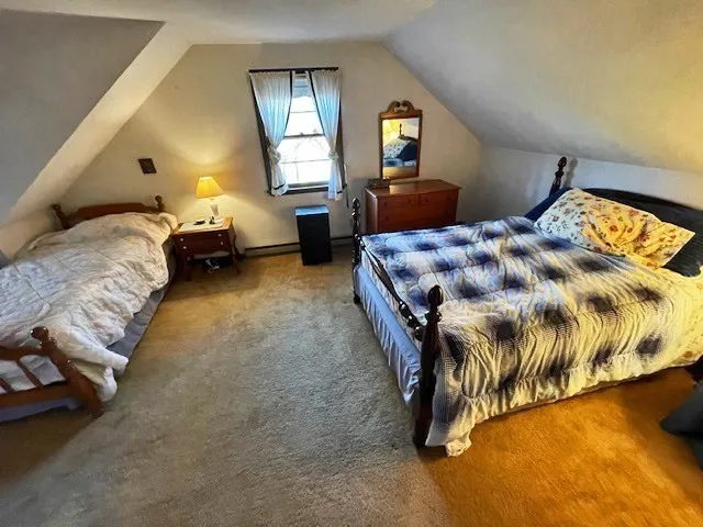 a bedroom with a bed and window