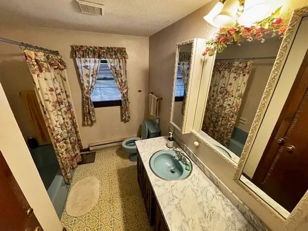 a bathroom with a tub sink and mirror
