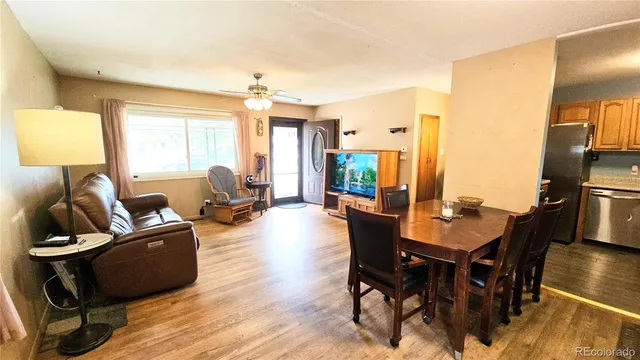 a view of a dining room with furniture window and wooden floor