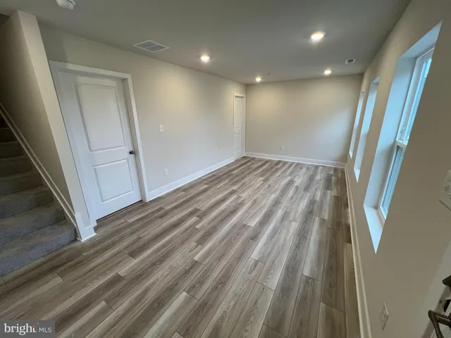 a view of hallway with wooden floor