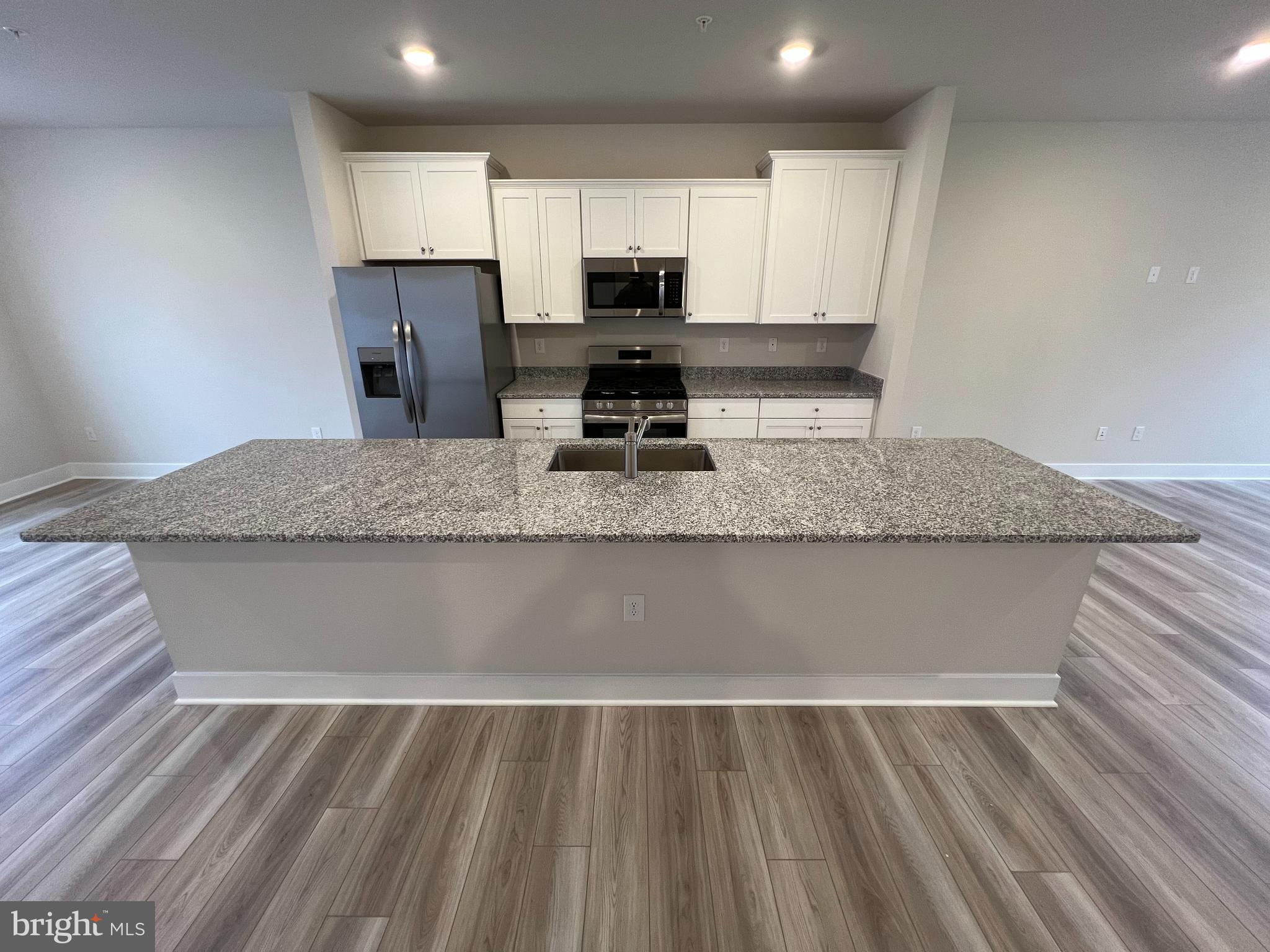 7232 Contee Road Laurel, MD 20707 - Photo 3 of 8 a view of kitchen sink microwave and cabinets