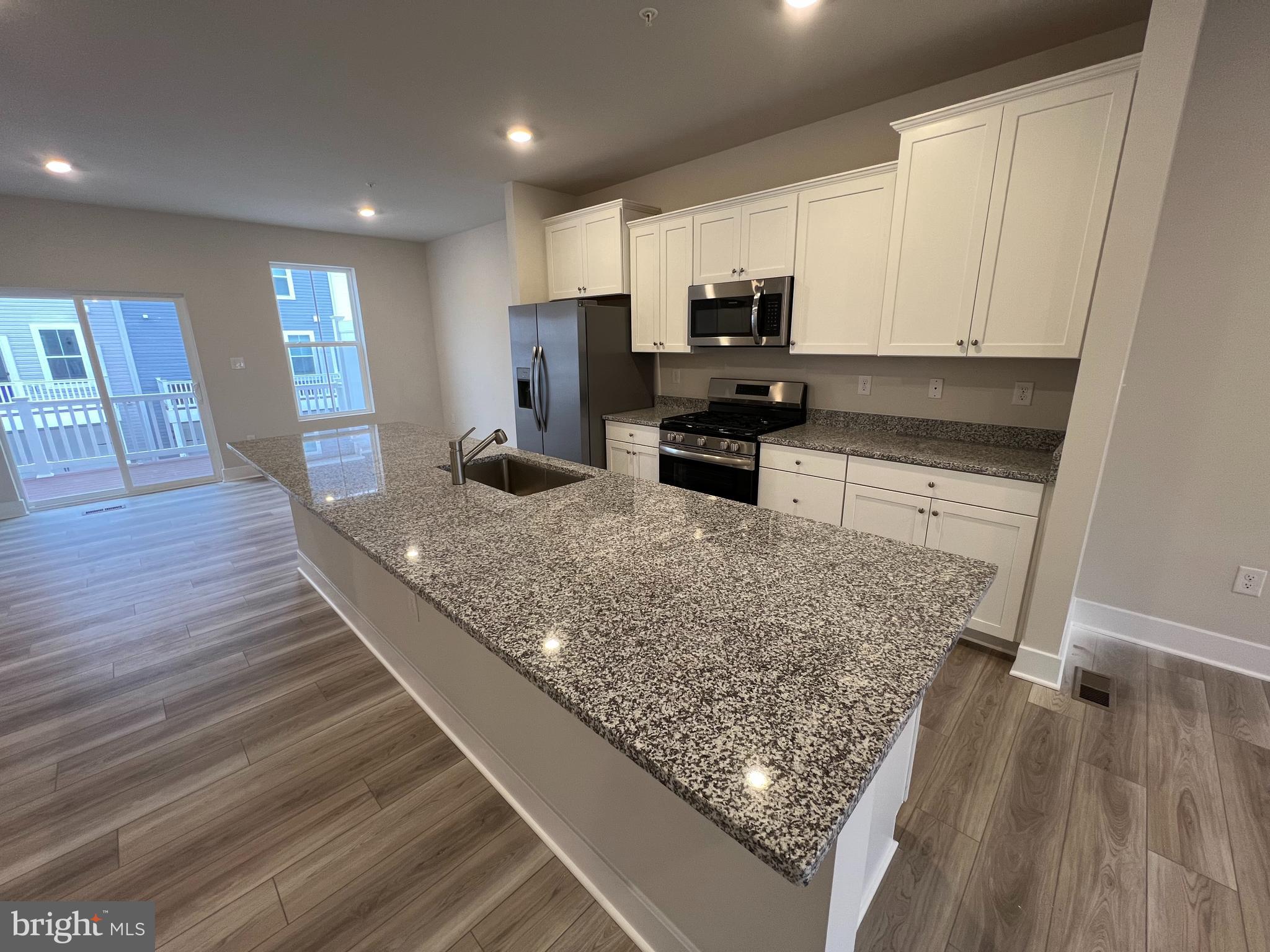 7232 Contee Road Laurel, MD 20707 - Photo 4 of 8 a kitchen with stainless steel appliances granite countertop a sink stove and refrigerator
