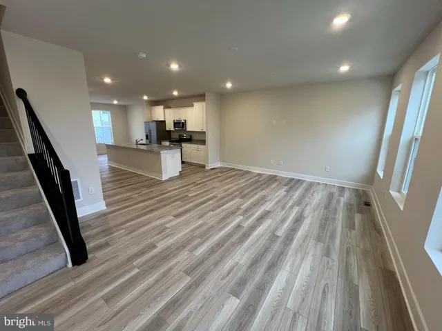 a view of kitchen with sink and refrigerator