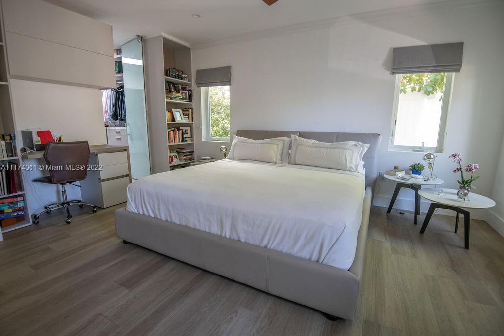 452 Woodcrest Road Key Biscayne, FL 33149 - Photo 11 of 23 a bedroom with a bed a chair and a potted plant on table