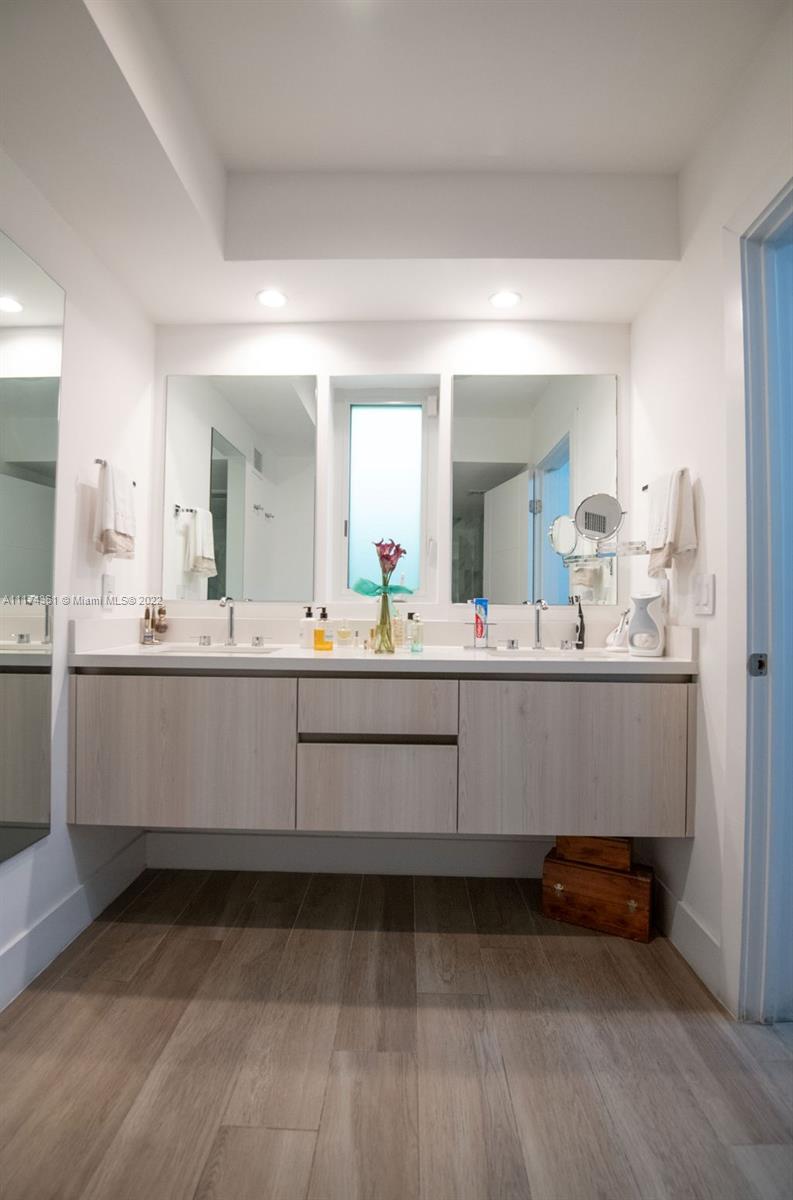 452 Woodcrest Road Key Biscayne, FL 33149 - Photo 12 of 23 a bathroom with a sink mirror and vanity