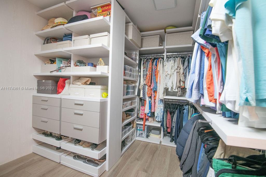 452 Woodcrest Road Key Biscayne, FL 33149 - Photo 13 of 23 a view of walk in closet with clothes and shoes