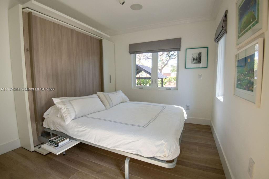452 Woodcrest Road Key Biscayne, FL 33149 - Photo 14 of 23 a bed sitting in a bedroom next to a window